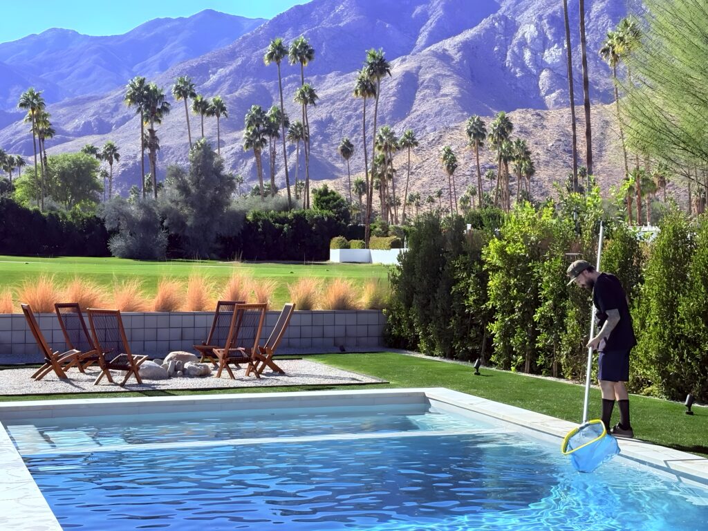 Chris Rossi of Rossi Pool Service cleaning a pool in Palm Springs, California.